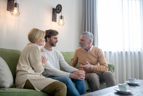 Adult child caring for aging parent while prioritizing mental health, caregiver wellness, and family support.